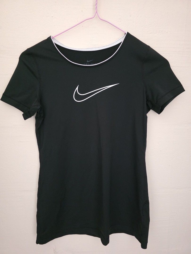 Nike Dri-FIT Black T-Shirt (Category: Activewear) located in Singapore. Submitted by tsy23 (Listing ID 1378360101, Image 1). Description: - Black Nike Dri-FIT t-shirt - White Nike logo - White trim around neckline - PTP 38cm, length 59cm.