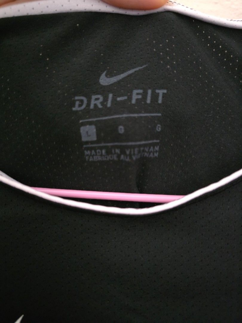 Nike Dri-FIT Black T-Shirt (Category: Activewear) located in Singapore. Submitted by tsy23 (Listing ID 1378360101, Image 3). Description: - Black Nike Dri-FIT t-shirt - White Nike logo - White trim around neckline - PTP 38cm, length 59cm.