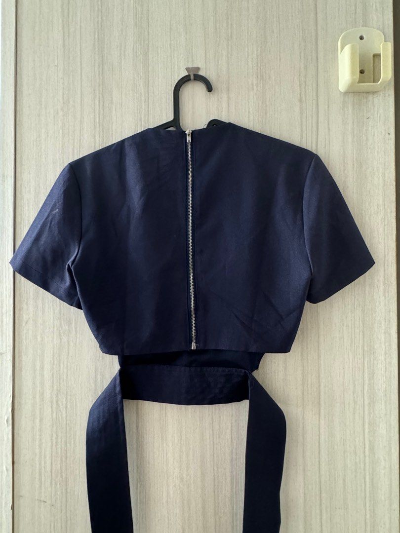 Tie back naval top (Category: Blouses) located in Singapore. Submitted by icemellon (Listing ID 1378510631, Image 2). Description: In between US 2 and 4 Lightly worn, with a barely noticeable tear at the bottom connecting to the ribbon. (Happy to provide a close-up picture) Selling because its too small for me now Meet up along the purple line.