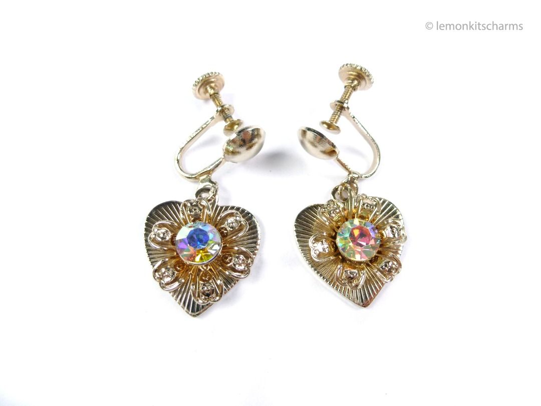 Vintage 1950s AB Rhinestone Heart Earrings, Screw backs, er2674-ci (Category: Earrings) located in Singapore. Submitted by lemonkitscharms (Listing ID 1378460587, Image 1). Description: Vintage 1950s AB Rhinestone Heart Earrings, screw-back style. Good condition, very minor scuffs, one age spot on the back of one heart. Fronts in very good condition. Goldtone with filigree flowers and a large ab rhinestone. Price excludes postage. Check my profil