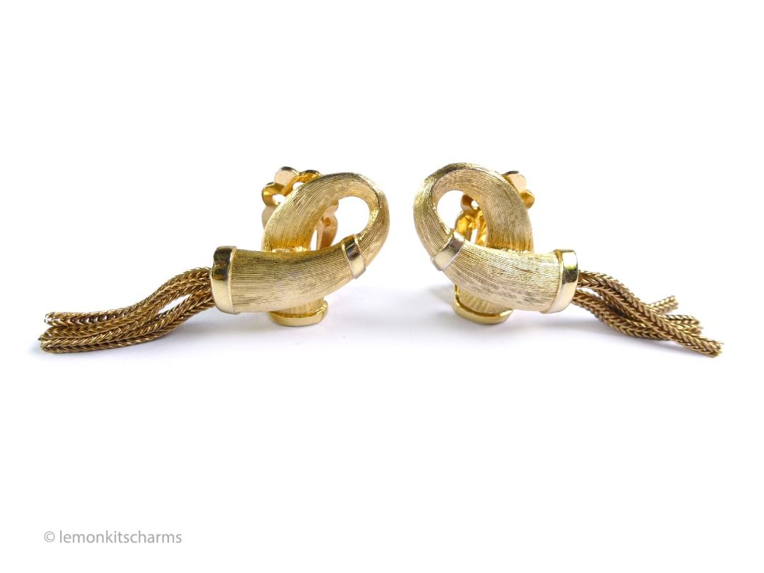 Vintage 1950s Looping Tassel Clip Earrings, er2675-ci (Category: Earrings) located in Singapore. Submitted by lemonkitscharms (Listing ID 1378460883, Image 3). Description: Vintage 1950s - 1960s Looping Tassel Clip Earrings. Unknown designer, clips are marked 'PAT.PEND.'. The quality is similar to Kramer or Trifari. Good condition, slight aging, minor wear, one earring has slight verdigris on the inner groove. Brushed goldtone loop design with ta