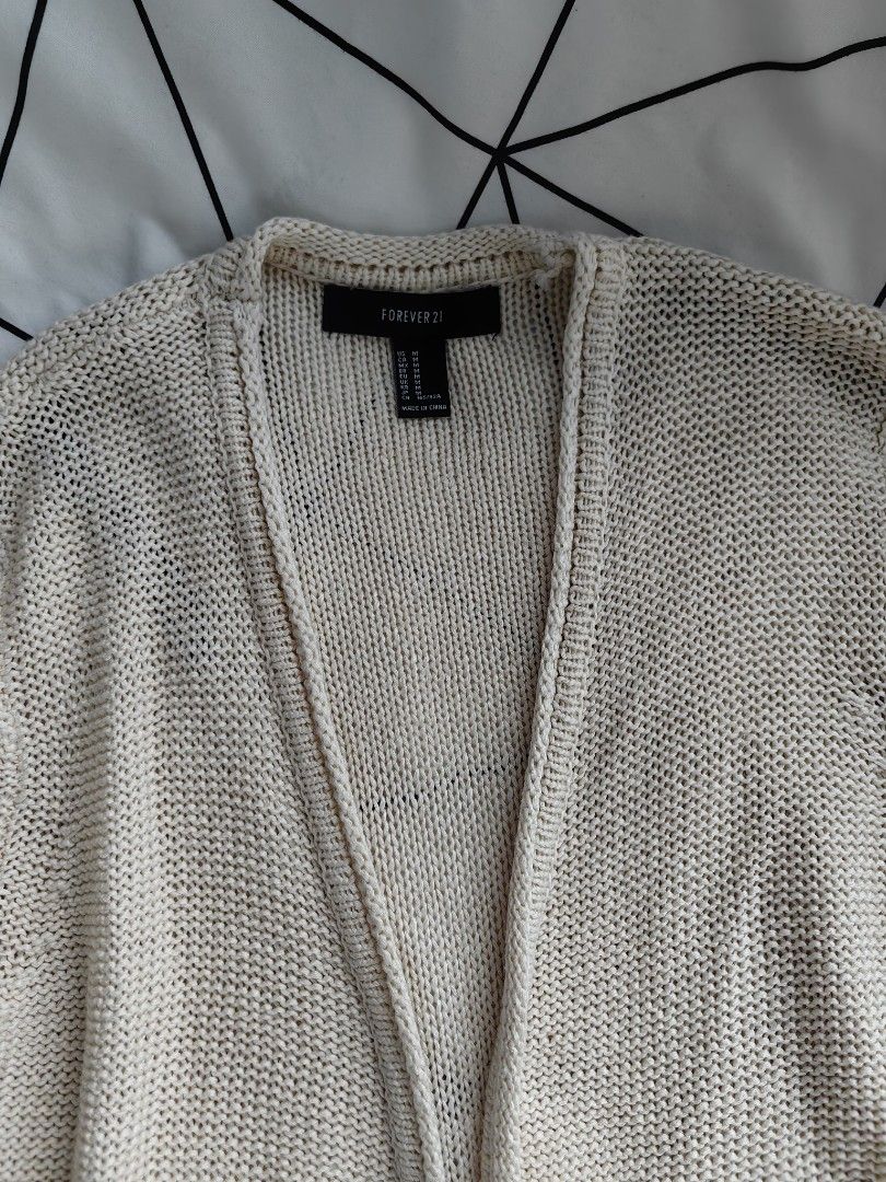 Forever 21 white knitted cardigan (Category: Others Tops) located in Manila. Submitted by sasaweee (Listing ID 1383780958, Image 3). Description: -Small to large frame - perfect for beach ootd -rfs: decluttering.