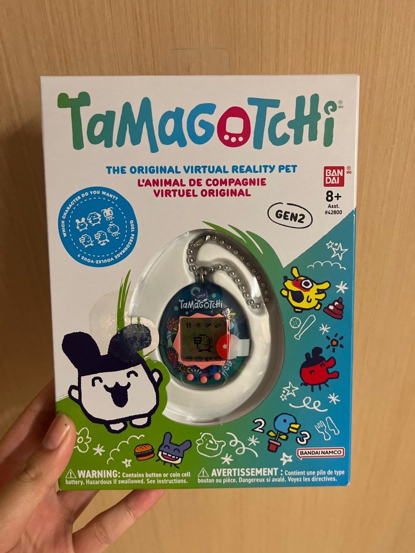 Tamagotchi Gen2 Virtual Pet (Category: Interactive Toys) located in Singapore. Submitted by nyeety (Listing ID 1383771963, Image 1). Description: - Brand new, unopened Tamagotchi Gen2 - Classic virtual pet gameplay - Raise and care for a digital creature - Comes with a chain for easy carrying - Perfect for collectors and nostalgic fun.