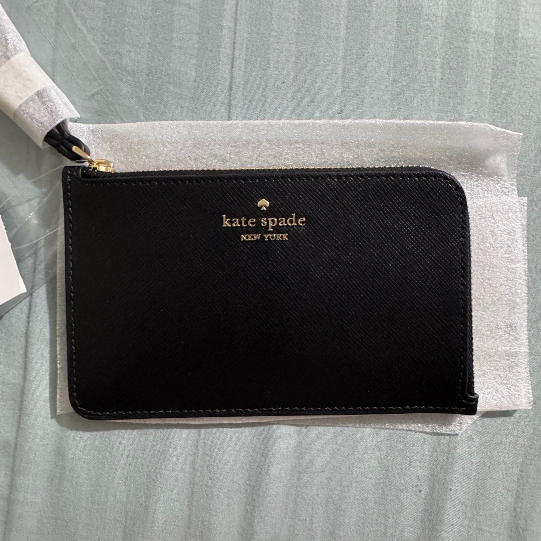 KATE SPADE Lucy Small L-Zip Wristlet (Category: Wallets & Card holders) located in Quezon City. Submitted by jolas. (Listing ID 1383867994, Image 1). Description: Brand new Authentic guaranteed from USA NO PAPER BAG Material: Saffiano PVC Color: Black Will send detailed pictures upon request.