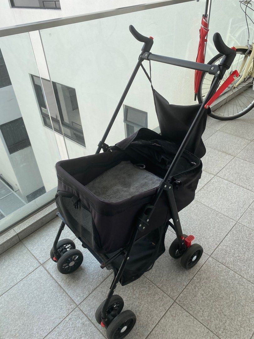 Black Pet Stroller dog stroller - Like New Condition (Category: Homes & Other Pet Accessories) located in Singapore. Submitted by sohovintage (Listing ID 1378591225, Image 1). Description: This pet stroller is in excellent condition, perfect for taking your furry friend on walks. Features a comfortable interior with a soft, grey lining. Includes a front storage pocket and easy-to-use folding mechanism. Wheels are in good condition..