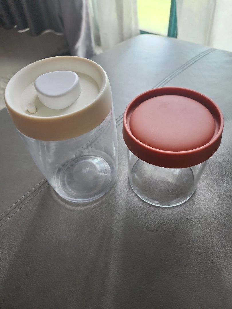 Clear Plastic Storage Containers with Lids (Category: Storage Boxes & Baskets) located in Singapore. Submitted by mnhak (Listing ID 1378604498, Image 1). Description: - Two clear plastic storage containers with lids. - One lid: reddish-brown. - One lid: beige rim with white button. - Perfect for dry goods and small items. - Excellent condition..