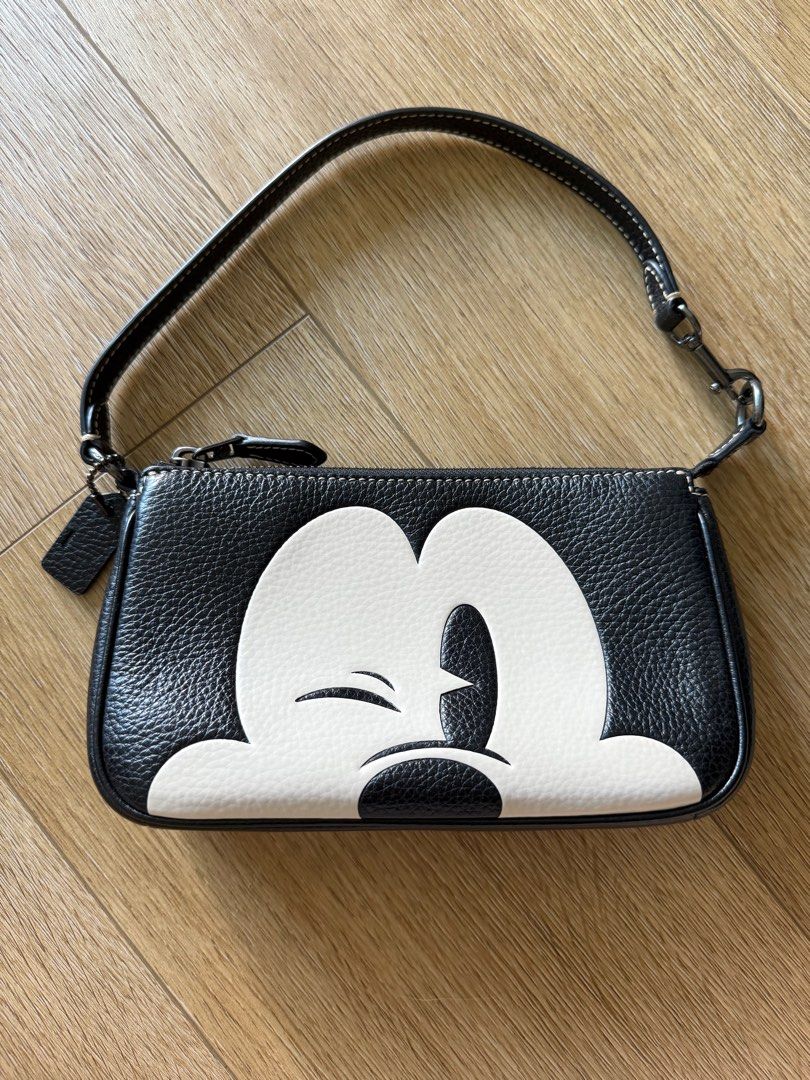 Coach Disney 100 Mickey Mouse Nolita 19 Wristlet Pouch Bag (Category: Bags & Wallets) located in Singapore. Submitted by leafsy (Listing ID 1378609961, Image 2). Description: Authentic Coach Disney Mickey Mouse wristlet bag. Features a black leather exterior with a Mickey Mouse design. Comes with a dust bag and tag. Perfect for carrying essentials. Great condition, like new. bought from coach outlet in Taiwan.