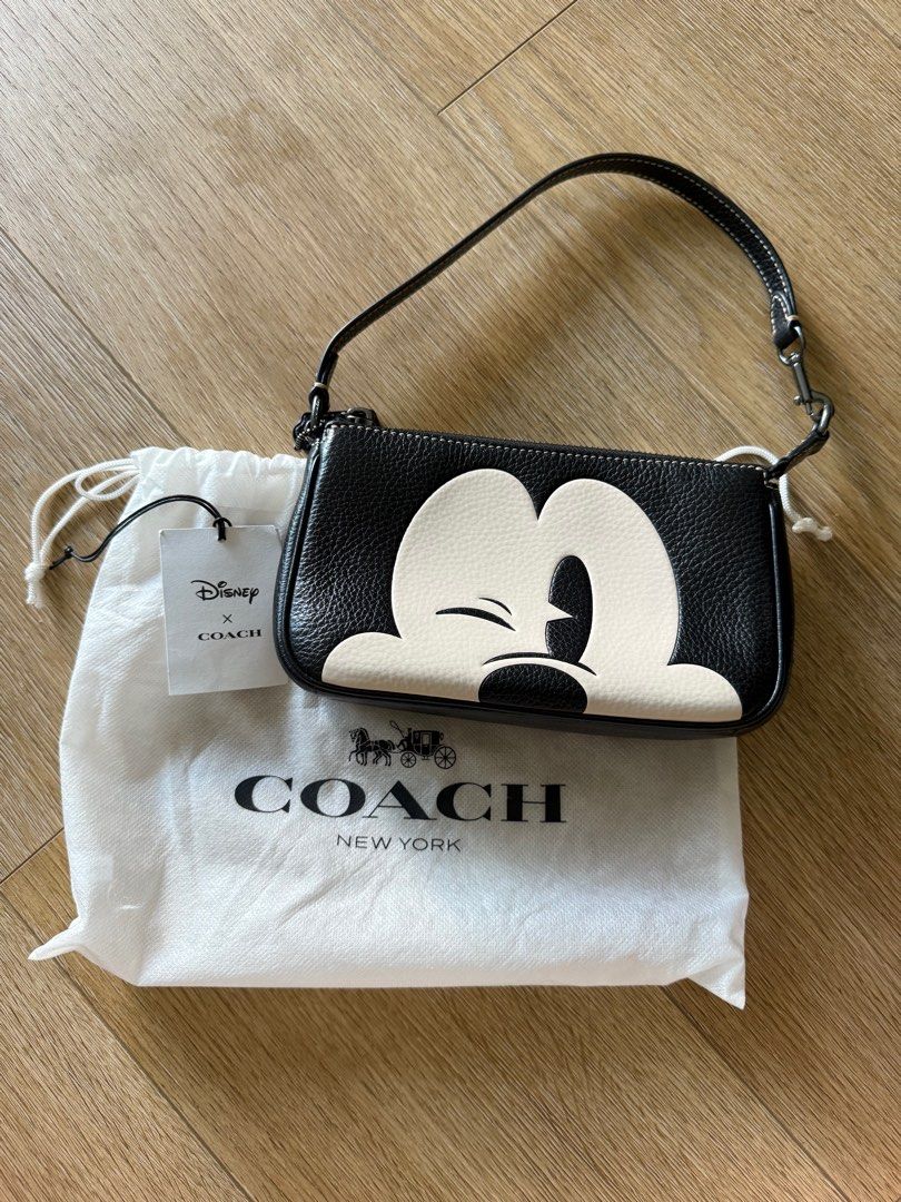 Coach Disney 100 Mickey Mouse Nolita 19 Wristlet Pouch Bag (Category: Bags & Wallets) located in Singapore. Submitted by leafsy (Listing ID 1378609961, Image 1). Description: Authentic Coach Disney Mickey Mouse wristlet bag. Features a black leather exterior with a Mickey Mouse design. Comes with a dust bag and tag. Perfect for carrying essentials. Great condition, like new. bought from coach outlet in Taiwan.