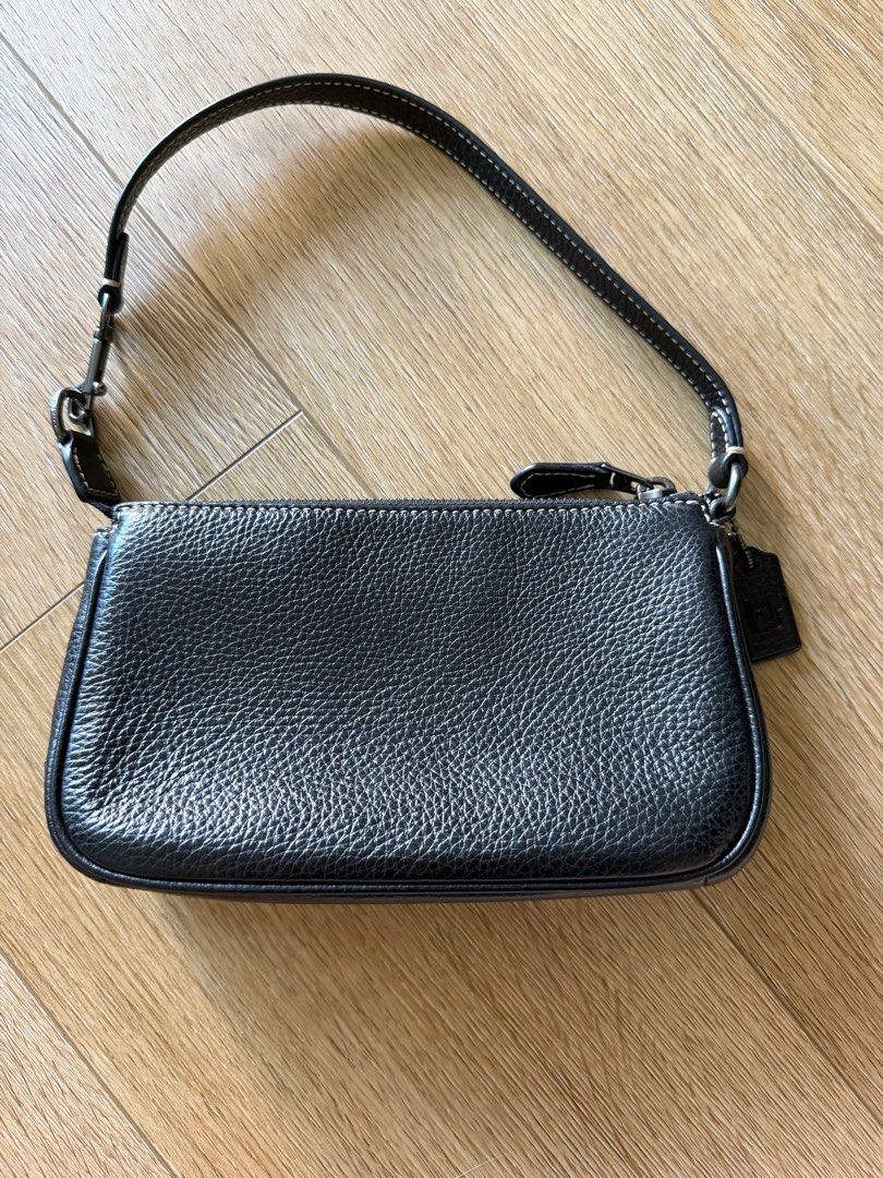 Coach Disney 100 Mickey Mouse Nolita 19 Wristlet Pouch Bag (Category: Bags & Wallets) located in Singapore. Submitted by leafsy (Listing ID 1378609961, Image 3). Description: Authentic Coach Disney Mickey Mouse wristlet bag. Features a black leather exterior with a Mickey Mouse design. Comes with a dust bag and tag. Perfect for carrying essentials. Great condition, like new. bought from coach outlet in Taiwan.