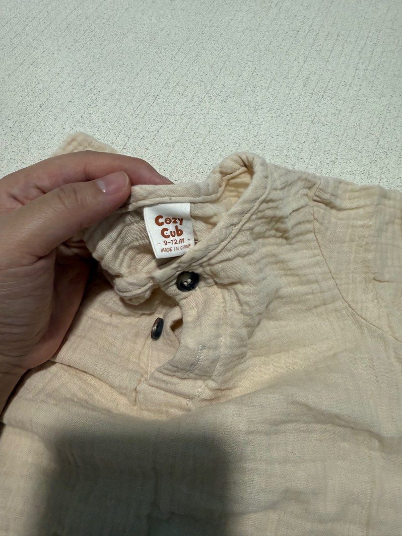 Cozy Cub Baby Outfit - 9-12M (Category: Babies & Kids Fashion) located in Singapore. Submitted by mimitan18 (Listing ID 1378687588, Image 2). Description: Adorable Cozy Cub baby outfit. Includes a beige top with button details and brown shorts. Made of soft, textured fabric. Perfect for your little one! Size 9-12 months..