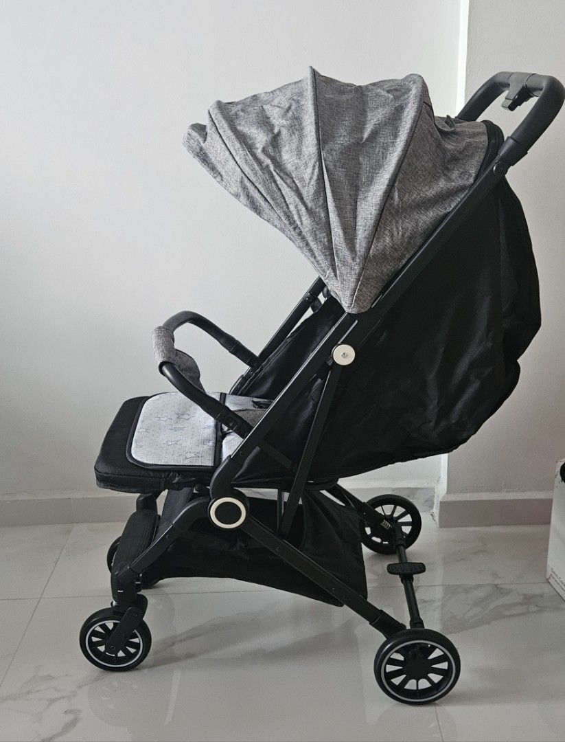Lightweight Stroller - Grey (Category: Strollers) located in Singapore. Submitted by caezero (Listing ID 1378674793, Image 2). Description: - Unused - Compact and easy to fold stroller - Cabin size - Features a grey canopy and seat with a star pattern - Suitable for everyday use - Wheels are in good condition - Perfect for parents on the go - additional seat cushion for change - self collect at 530994.