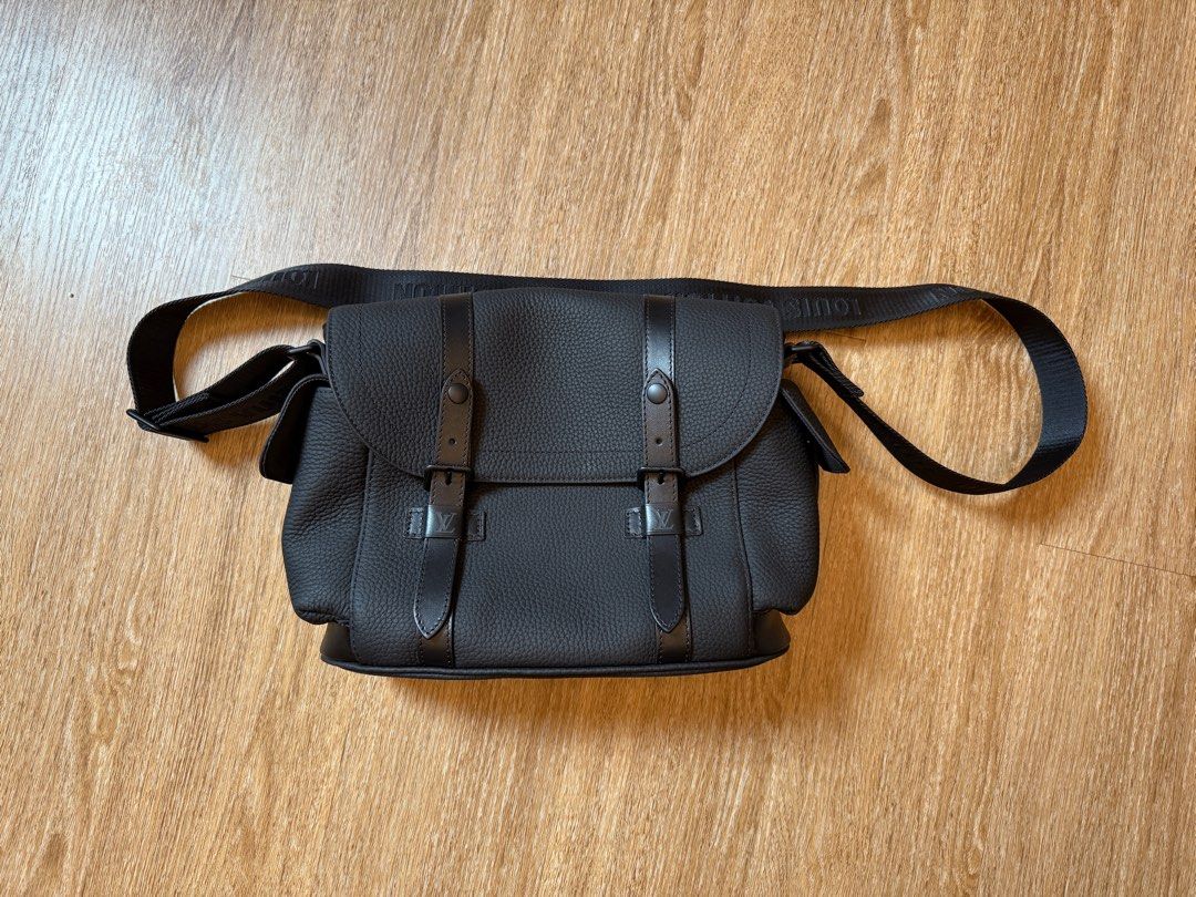 Louis Vuitton Messenger Bag - Black (Category: Bags & Wallets) located in Singapore. Submitted by letgoofthings (Listing ID 1378673487, Image 1). Description: Stylish Louis Vuitton messenger bag in excellent condition. Features a textured black leather exterior with a secure flap closure and adjustable shoulder strap. The interior includes multiple compartments for organization. Perfect for everyday use or travel..