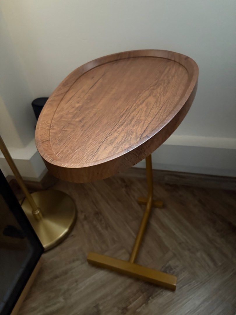 Side Table (Category: Tables & Sets) located in Singapore. Submitted by rehomingmypreloved (Listing ID 1378595567, Image 1). Description: Oval top with gold legs side table that can also be slid under a couch or bed as a side table - depending on the height :).