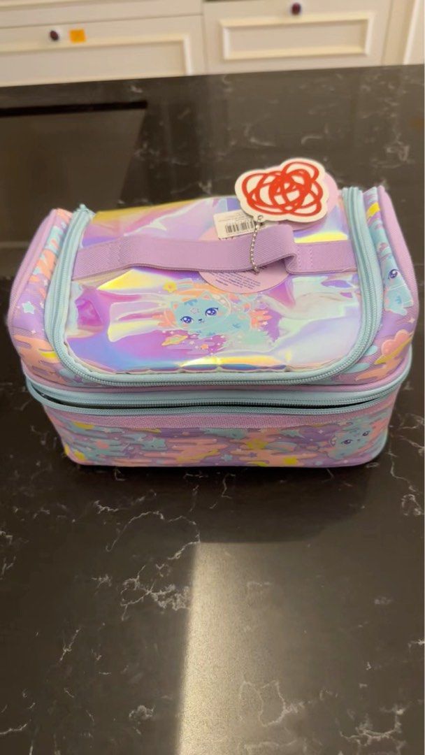 Smiggle Double Decker Lunchbox - Iridescent Design (Category: Babies & Kids Fashion) located in Singapore. Submitted by blissfully28 (Listing ID 1378619915, Image 1). Description: Hey there! Check out this super cute Smiggle Double Decker Lunchbox! It's brand new with the tag still on, so you know it's in perfect condition. The design is so fun and colorful, with an iridescent finish that catches the light beautifully. It has two compartments, pe