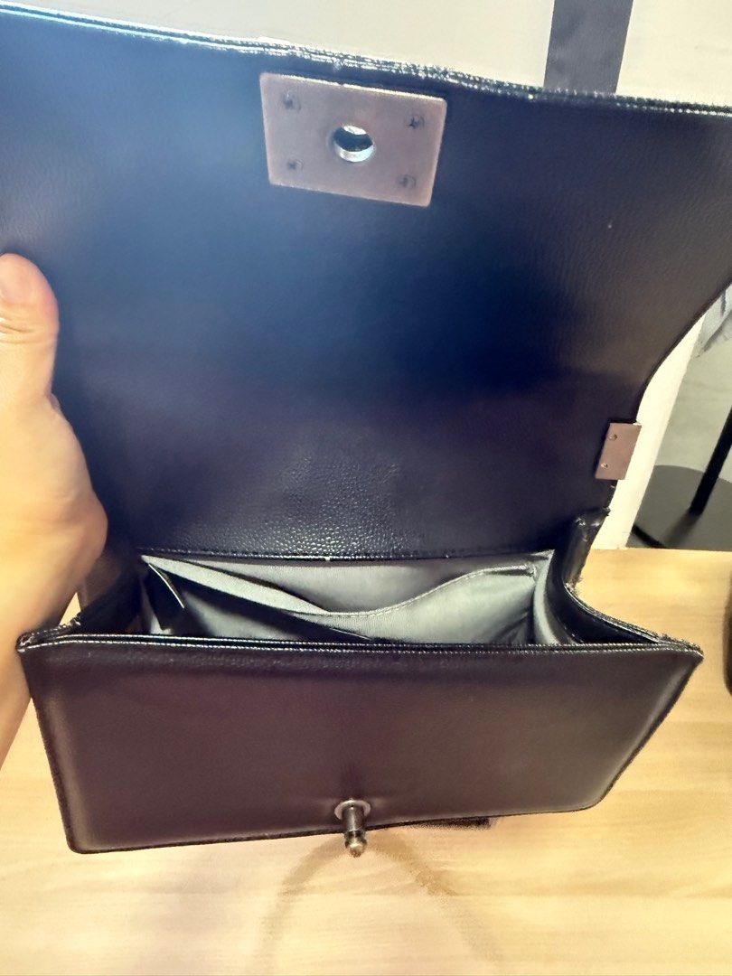 Chanel Boy Bag - Black (Category: Bags & Wallets) located in Singapore. Submitted by vanessanna (Listing ID 1378821784, Image 1). Description: Authentic Chanel Boy Bag in black. Features a quilted design and silver-tone hardware. The interior has multiple compartments for organization. Includes a chain strap for shoulder or crossbody wear. Bought from thrift store .