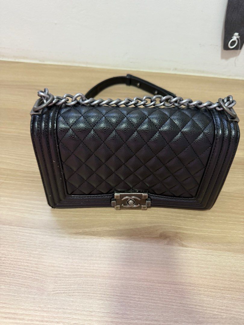Chanel Boy Bag - Black (Category: Bags & Wallets) located in Singapore. Submitted by vanessanna (Listing ID 1378821784, Image 2). Description: Authentic Chanel Boy Bag in black. Features a quilted design and silver-tone hardware. The interior has multiple compartments for organization. Includes a chain strap for shoulder or crossbody wear. Bought from thrift store .