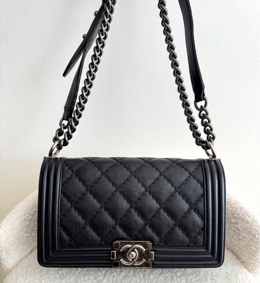 Chanel Medium Boy Bag - Black (Category: Bags & Wallets) located in Singapore. Submitted by mdmnus (Listing ID 1378842346, Image 1). Description: Authentic Chanel Boy Bag in classic black. Features diamond quilting, a chain strap, and the iconic CC clasp. The bag shows minimal signs of wear, with a clean interior. Come with dustbag. .