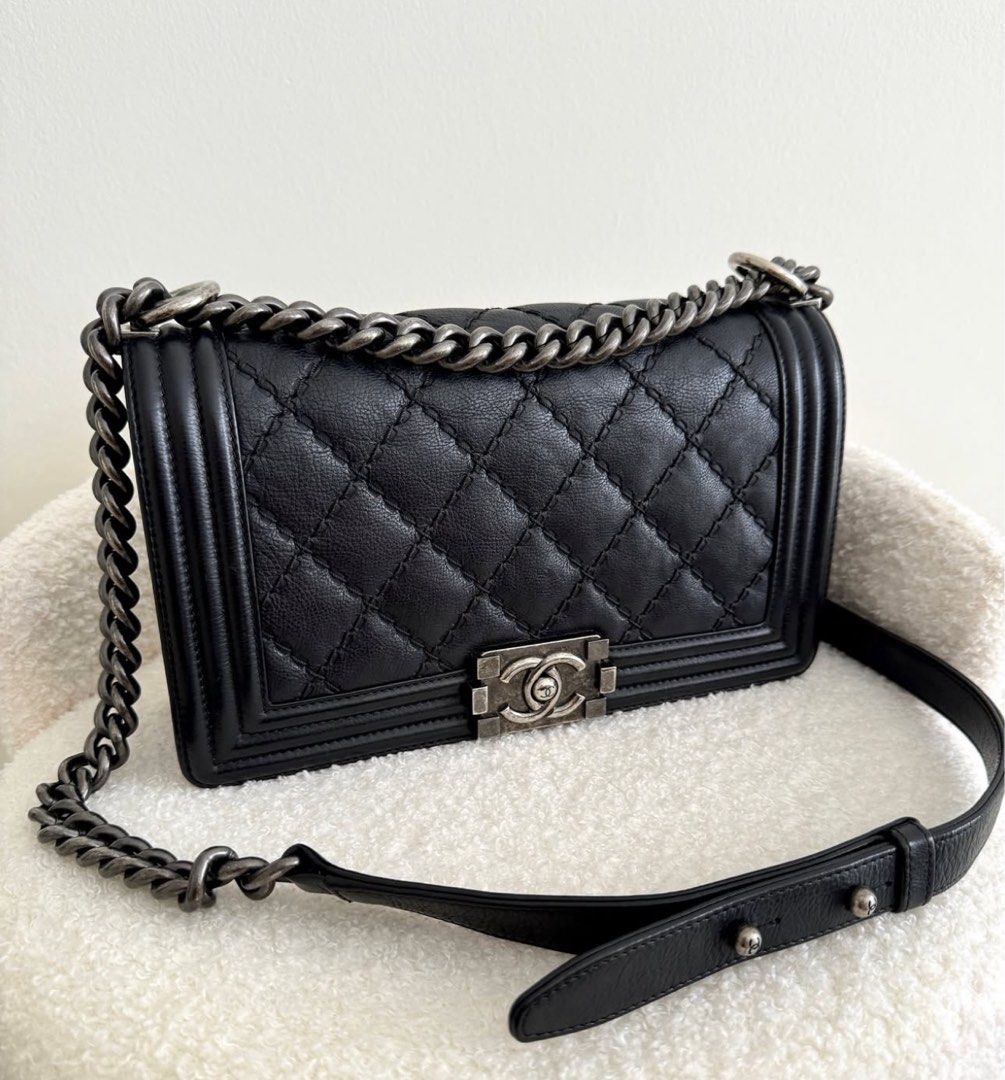 Chanel Medium Boy Bag - Black (Category: Bags & Wallets) located in Singapore. Submitted by mdmnus (Listing ID 1378842346, Image 3). Description: Authentic Chanel Boy Bag in classic black. Features diamond quilting, a chain strap, and the iconic CC clasp. The bag shows minimal signs of wear, with a clean interior. Come with dustbag. .