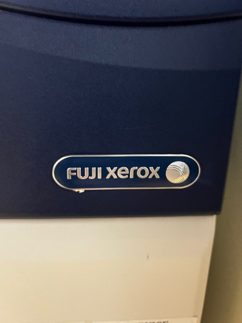 Fuji Xerox Printer -DocuCentre-V C2263 (Category: Printers, Scanners & Copiers) located in Singapore. Submitted by hhhwwwggg (Listing ID 1378735438, Image 2). Description: This is a Xerox photocopier. Can print black & colour , scan document and fax.It appears to be in good condition. It has a blue and black panel on the front. It has a paper tray at the bottom. It looks like it is in an office setting. It has a scanner on the top. It has a scree