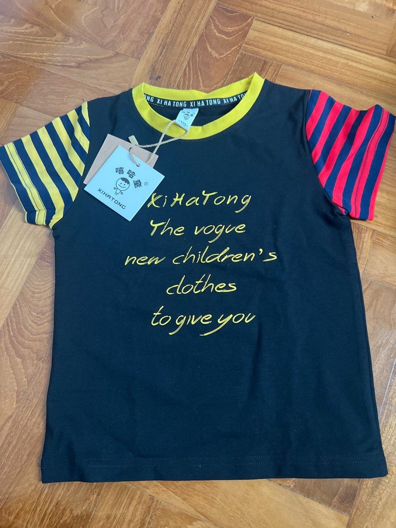 Kids' T-shirt (Category: Babies & Kids Fashion) located in Singapore. Submitted by timewrapper (Listing ID 1378730813, Image 1). Description: Cute kids' t-shirt with a unique design. Features a black body with yellow and red striped sleeves. The collar is yellow. Brand new with tags..