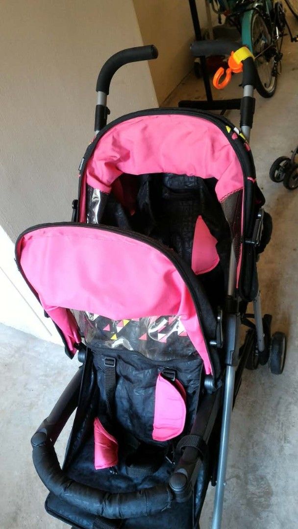 Pink and Black Stroller (Category: Strollers) located in Singapore. Submitted by alpter (Listing ID 1378766504, Image 1). Description: - Pink canopy and accents, black seat - Good working condition - Clear plastic window on canopy - Easy to maneuver with handle and wheels.