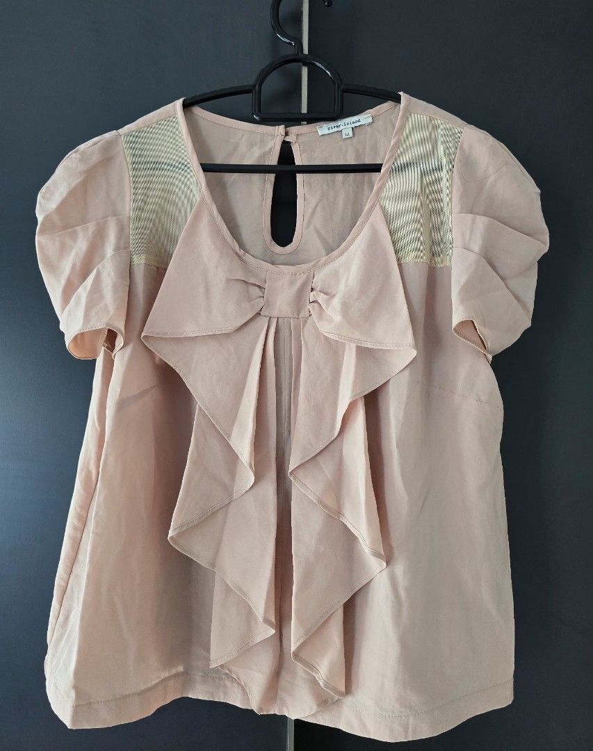 RIVER ISLAND Nude-colour Vintage Blouse with Bow Detail + Translucent Mesh Panel (Category: Blouses) located in Singapore. Submitted by lttow (Listing ID 1378717718, Image 1). Description: This was bought from River Island UK some years ago. It's an elegant office wear that's got a soft pink-nude hue. Features a unique frontal bow/ruffles detail and sheer mesh paneling at the neckline/collarbone. Perfect for adding a touch of sophistication to an