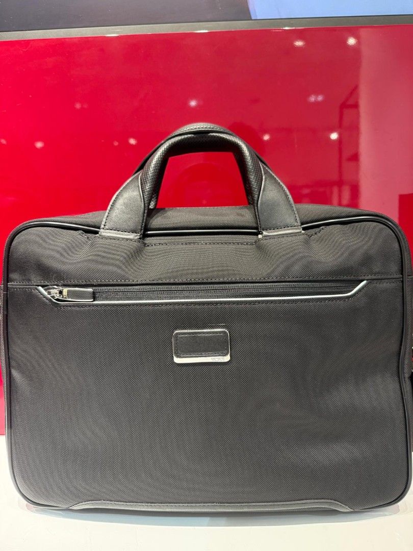 Tumi Briefcase - Black Arrive (Category: Laptop Bags & Sleeves) located in Singapore. Submitted by Dinobong (Listing ID 1378920445, Image 3). Description: - Tumi briefcase in excellent condition - Sleek black design - Multiple compartments for organization - Includes top handle and detachable shoulder strap - Perfect for professionals -Got it from lucky draw winning -It Legit item from Tumi.
