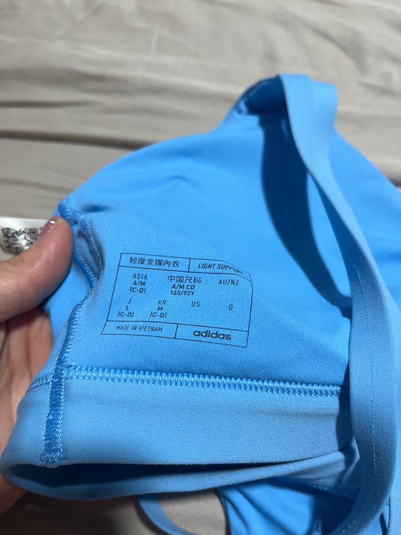 [Only one on Carousell] Adidas Light Support Sports Bra - Blue - A/M Badminton Yoga Pickleball Pilates Running Sport (Category: Activewear) located in Singapore. Submitted by blazerunner (Listing ID 1379088454, Image 2). Description: Function 10/10, cosmetic 10/10 Suitable for S-M (too tight for me) Final sale non nego tracked mailing $3, pick up 550551 Adidas light support sports bra in a beautiful light blue color. Features a stylish design wit
