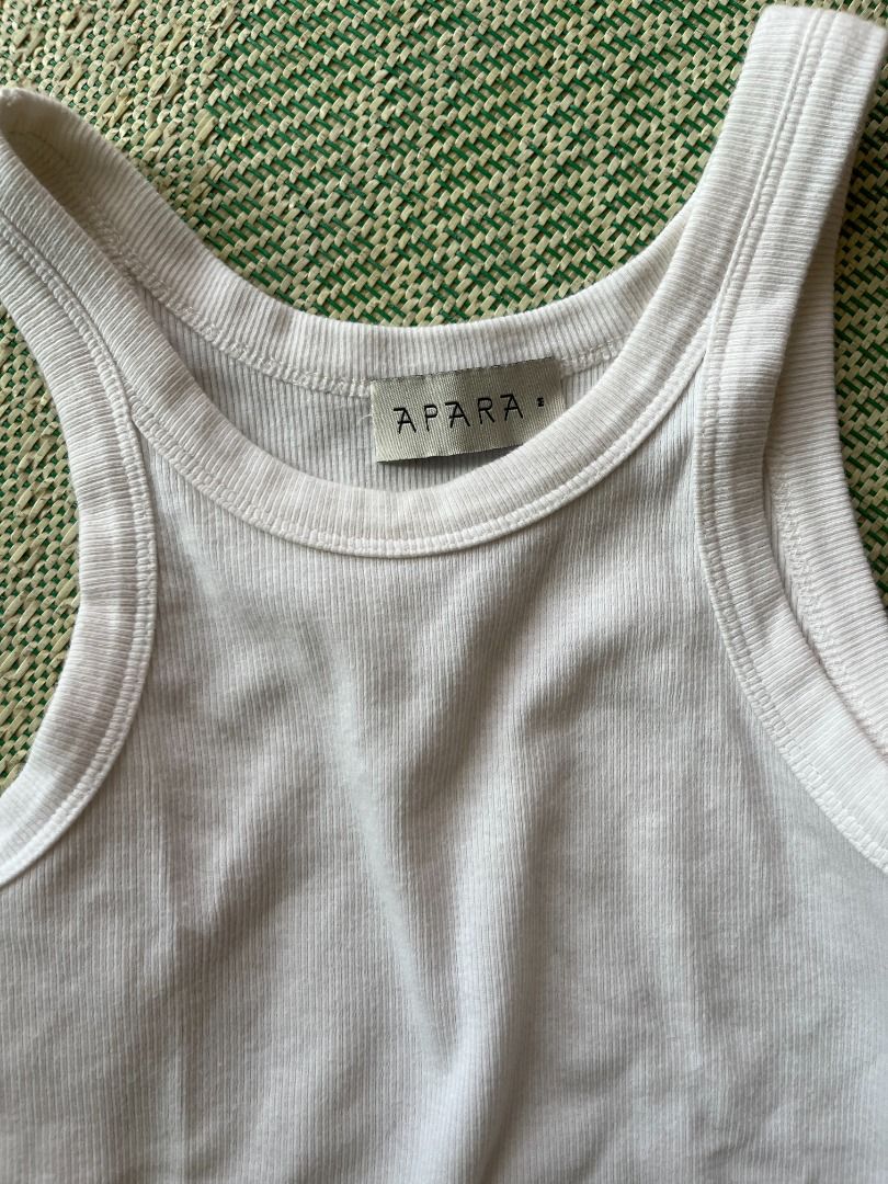 Apara white sleeveless ribbed tank (Category: Sleeveless) located in Manila. Submitted by nikkinat (Listing ID 1379020008, Image 3). Description: Apara sleeveless ribbed tank in white. This was part of their early collections. Good quality tank but I don't like how it fits on me, as a thicc, short-torsoed girly. Also has some slight discoloration around the armpit area cos of my deo, but it's not super noticeable unless you look hard! They don't 