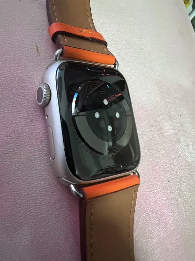 Apple Watch Series 9 with Orange Leather Band (Category: Wearables & Smart Watches) located in Singapore. Submitted by kevinsun1959 (Listing ID 1379100985, Image 1). Description: Apple Watch Series 9 is in excellent condition. Comes with an orange leather band and a charging dock. The screen is perfect, with no scratches or dead pixels..