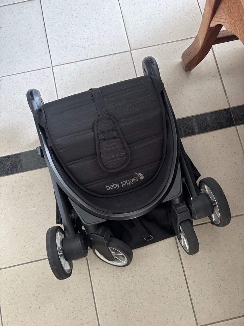 Baby Jogger City Tour 2 Stroller - Black (Category: Strollers) located in Singapore. Submitted by yoshinocherry (Listing ID 1378922565, Image 3). Description: Compact and lightweight Baby Jogger City Tour 2 stroller in black. Features a large sun canopy with SPF 50+ protection. Shows some signs of wear, including minor scratches and one side of the canopy hook is broken (fixed using O ring), but is otherwise in good condition and fully functional