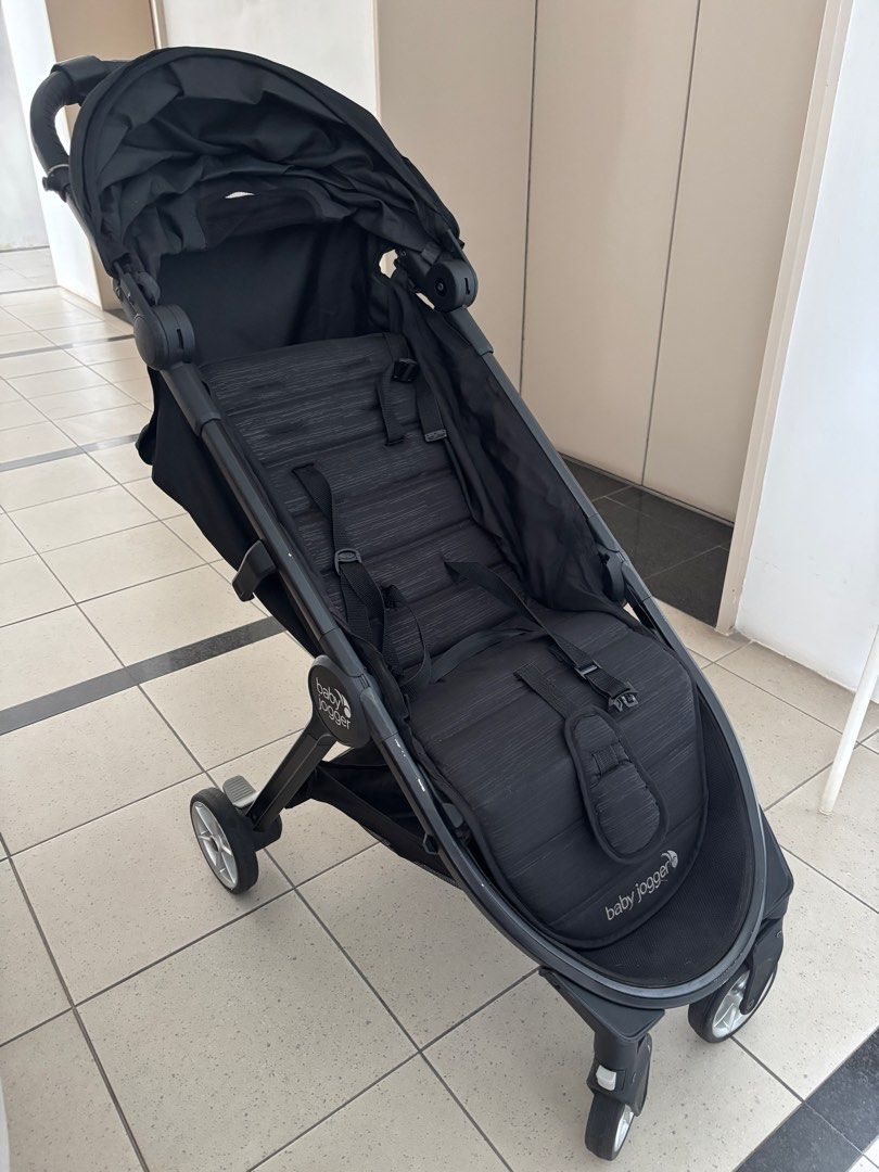 Baby Jogger City Tour 2 Stroller - Black (Category: Strollers) located in Singapore. Submitted by yoshinocherry (Listing ID 1378922565, Image 1). Description: Compact and lightweight Baby Jogger City Tour 2 stroller in black. Features a large sun canopy with SPF 50+ protection. Shows some signs of wear, including minor scratches and one side of the canopy hook is broken (fixed using O ring), but is otherwise in good condition and fully functional