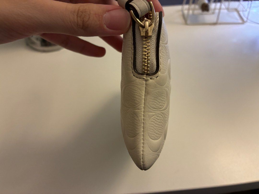 Coach Corner Zip Wristlet in Signature Leather (Category: Bags & Wallets) located in Singapore. Submitted by jaschui295 (Listing ID 1379102907, Image 3). Description: Authentic Coach Corner Zip Wristlet in Chalk/Gold. Features signature leather with a wrist strap. Interior has multiple card slots. Comes with care instructions and original tag. Perfect for everyday use Bought on 29th May 2025, no longer have original packaging or tags, only have d