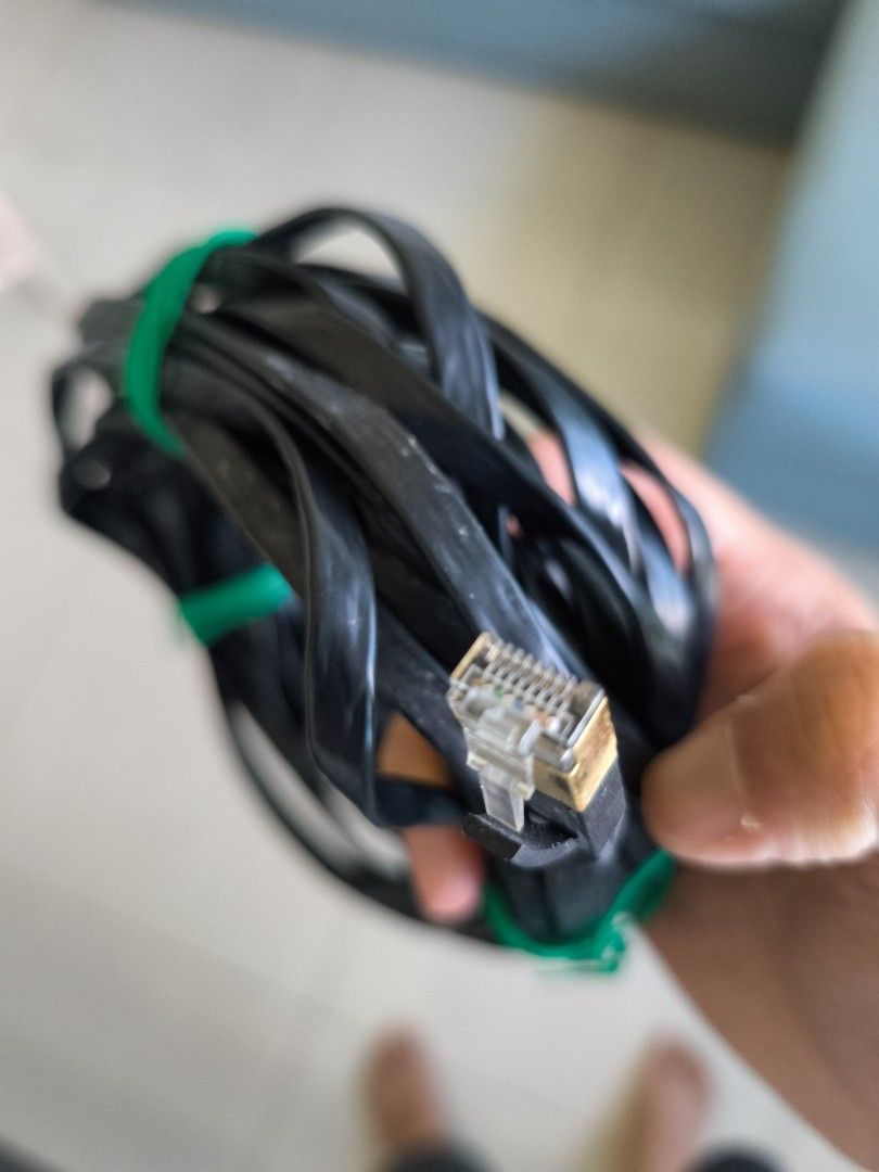 Flat Ethernet Cable (Category: Cables & Adaptors) located in Singapore. Submitted by double_a (Listing ID 1378945985, Image 2). Description: - Black Ethernet cable - Includes green rubber band - Gold-plated connector - Good condition.