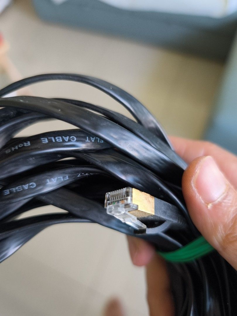 Flat Ethernet Cable (Category: Cables & Adaptors) located in Singapore. Submitted by double_a (Listing ID 1378945985, Image 3). Description: - Black Ethernet cable - Includes green rubber band - Gold-plated connector - Good condition.