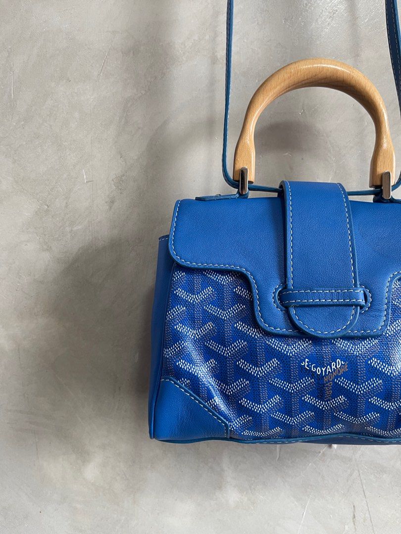 Goyard Blue Mini Goyardine Saigon (Category: Luxury Bags & Wallets) located in Cavite. Submitted by second_story_ph (Listing ID 1378955830, Image 2). Description: Goyard Blue Mini Goyardine Saigon The Mini Saigon features a coated canvas body with leather trim, a wooden top handle, a removable flat leather strap, a front flap with slip-through closure, and an interior slip pocket. It carries an AB condition rating. Reasonable price. Exterior Corn