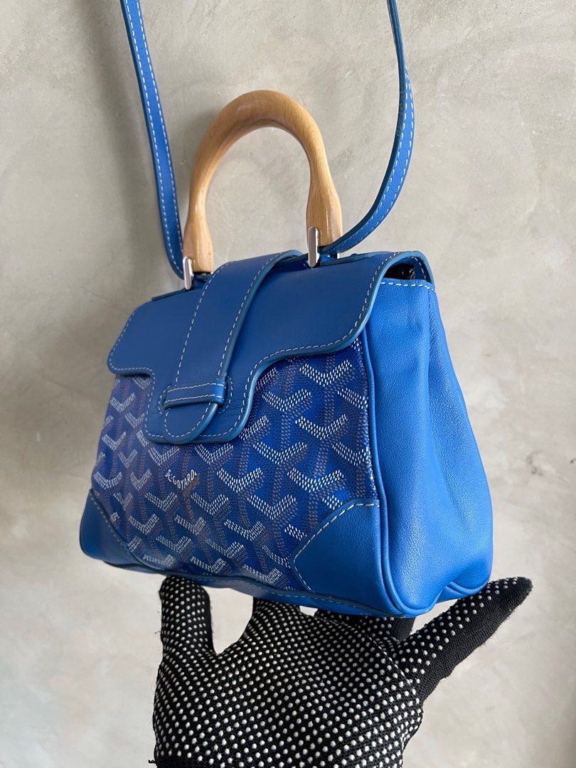 Goyard Blue Mini Goyardine Saigon (Category: Luxury Bags & Wallets) located in Cavite. Submitted by second_story_ph (Listing ID 1378955830, Image 3). Description: Goyard Blue Mini Goyardine Saigon The Mini Saigon features a coated canvas body with leather trim, a wooden top handle, a removable flat leather strap, a front flap with slip-through closure, and an interior slip pocket. It carries an AB condition rating. Reasonable price. Exterior Corn