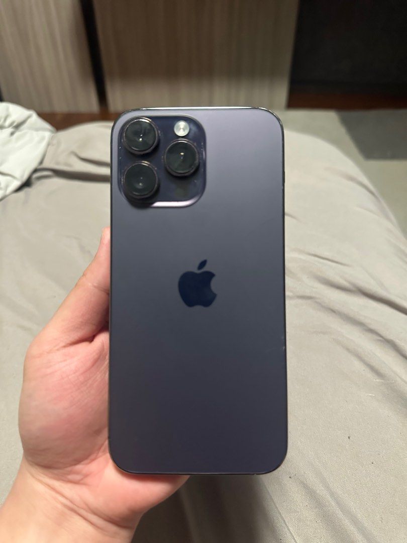 Iphone 14 pro max Purple 128GB (Category: iPhone 14 Series) located in Singapore. Submitted by ovavtg (Listing ID 1379106976, Image 1). Description: The phone powers on and functions, no flaws The back glass has a small crack which can only be seen in certain angles (refer pic 3). The screen has no cracks, only screenprotector (which u can choose to remove upon buying, is $50 so kept it if the future buyer wants). No charger or accessories includ