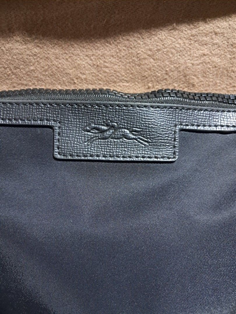 Longchamp Le Pliage Neo Clutch Bag (Category: Luxury Bags & Wallets) located in Butuan. Submitted by fabchichub (Listing ID 1379003318, Image 2). Description: This clutch is designed to hold all of your daily essentials. Its handle allows it to be carried by hand or worn over the shoulder, like a small bag. Spacious and light, the LE PLIAGE is the ideal companion for the modern city woman. The models are adorned with satin-finish nylon, embellish