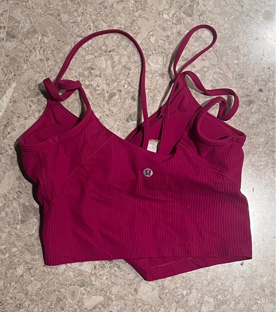Lululemon Ribbed Yoga Tank Top - Size 6 (Category: Activewear) located in Singapore. Submitted by tolliason (Listing ID 1379107911, Image 1). Description: This Lululemon yoga cropped tank top is in excellent condition. It features a unique strap design and a flattering ribbed texture. Perfect for yoga, pilates, or everyday wear. The size is a 4. The colour is dark pink..