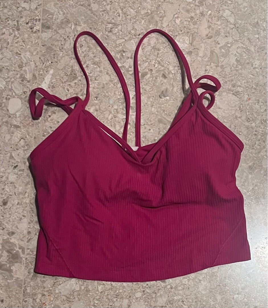 Lululemon Ribbed Yoga Tank Top - Size 6 (Category: Activewear) located in Singapore. Submitted by tolliason (Listing ID 1379107911, Image 2). Description: This Lululemon yoga cropped tank top is in excellent condition. It features a unique strap design and a flattering ribbed texture. Perfect for yoga, pilates, or everyday wear. The size is a 4. The colour is dark pink..