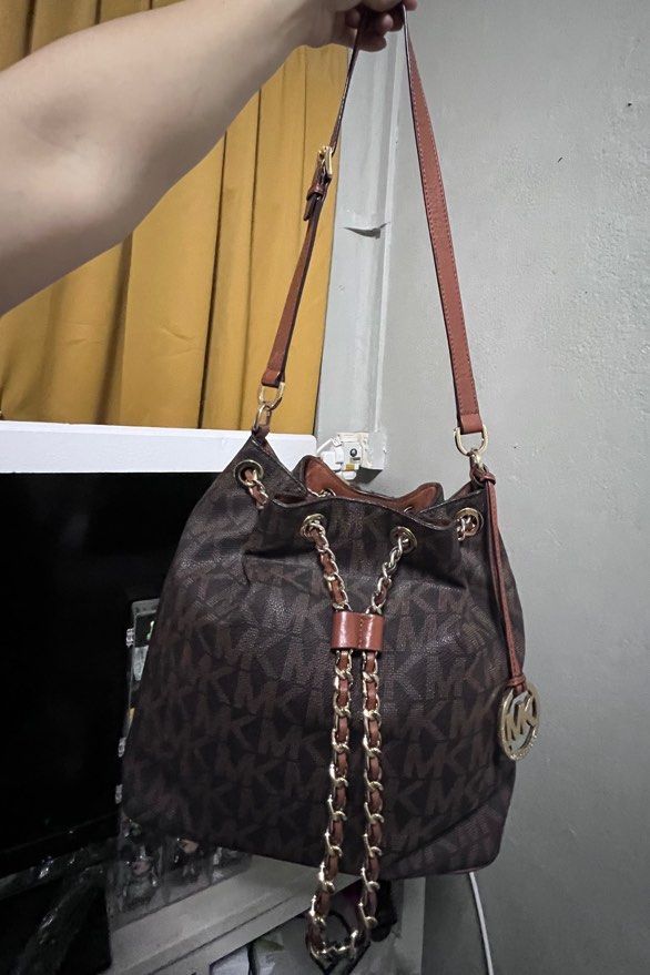 Michael Kors Bucket Bag (Category: Bags & Wallets) located in Singapore. Submitted by live.love.laugh. (Listing ID 1379074833, Image 1). Description: Authentic Michael Kors monogram bucket bag in good condition. Features a MK logo print, gold chain and leather accents. Seldom used. Interior shows some signs of wear. Perfect for everyday use! .
