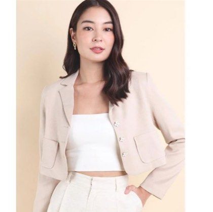 NEONMELLO CARINNE CROPPED CLOVER BLAZER IN CREAM (Category: Coats, Jackets and Outerwear) located in Singapore. Submitted by 888huatah8888 (Listing ID 1379087446, Image 3). Description: Stylish beige cropped blazer. Features a classic design with two front pockets and button closure. Perfect for layering and adding a touch of sophistication to any outfit. The blazer is in excellent condition, ready to elevate your wardrobe. Introducing new colour