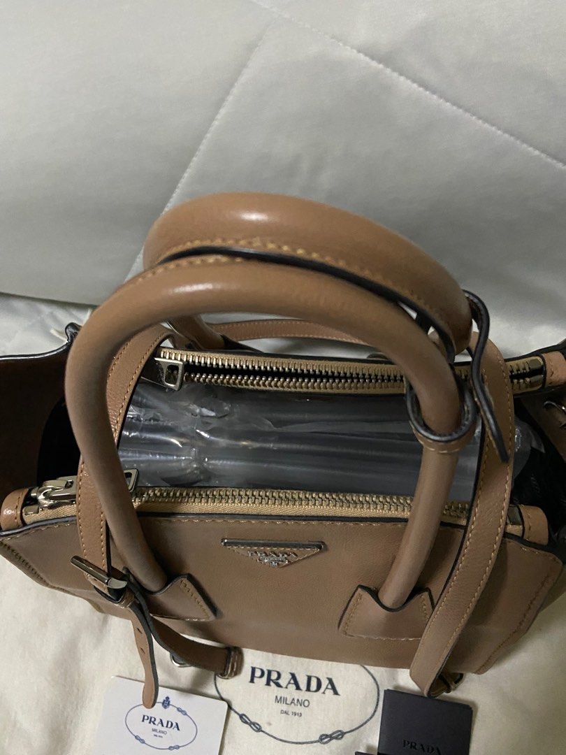 Prada bag (Category: Bags & Wallets) located in Singapore. Submitted by celini (Listing ID 1379073789, Image 3). Description: Bought from Spain 10’years ago. Condition as photo, no stain Authentic card & dust bag 21*27*19cm 100% authentic .