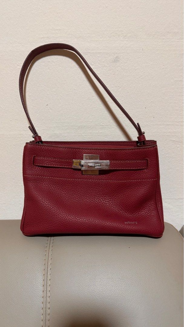 Rabeanco Red Leather Handbag (Category: Bags & Wallets) located in Singapore. Submitted by ikljn (Listing ID 1379090268, Image 2). Description: Beautiful handbag in a rich red leather and a secure clasp closure. The bag has a structured shape and a pebbled leather texture. Interior includes two small pocket. In excellent condition, with receipt.