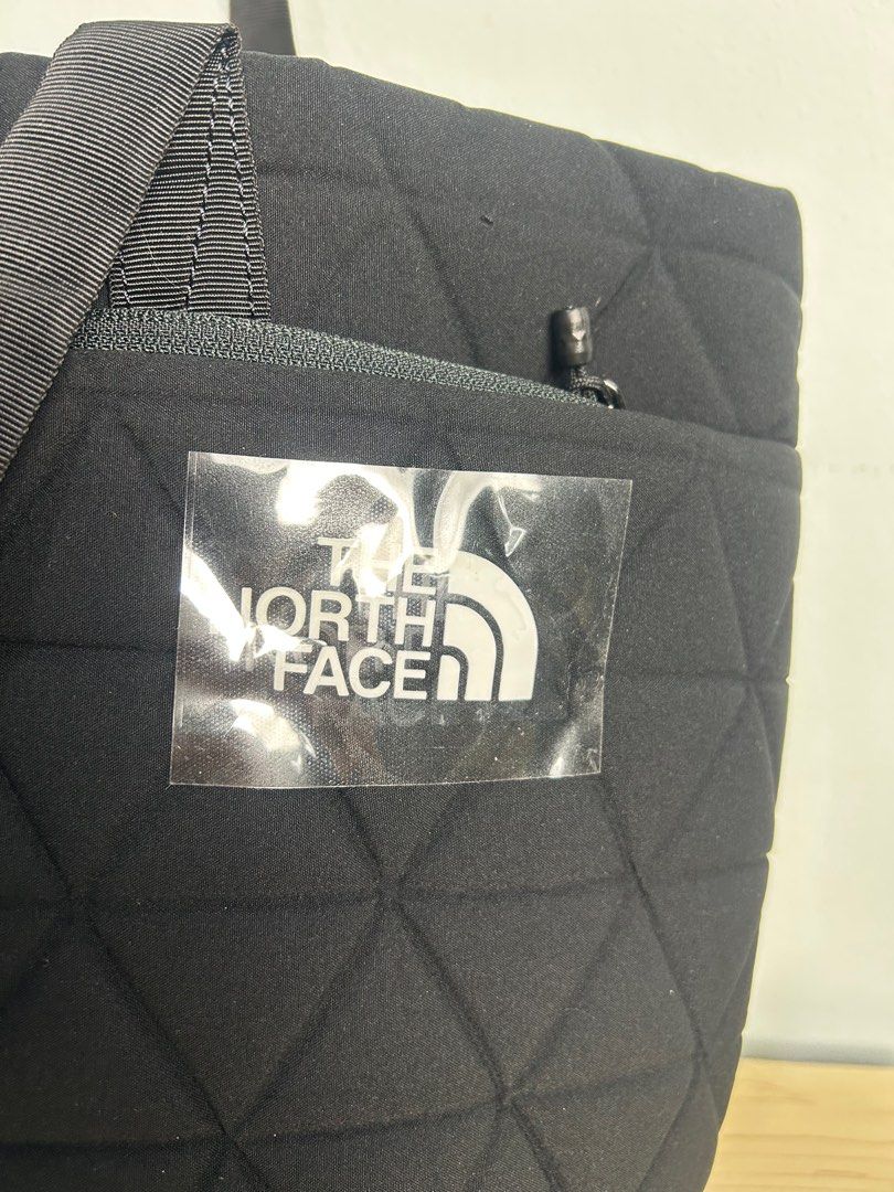 The North Face Geoface Tote Bag (Category: Tote Bags) located in Singapore. Submitted by bolaverse (Listing ID 1378505857, Image 3). Description: Selling a brand new North Face Geoface Tote Bag Backpack Excellent as a daybag Very beautiful bag. Very rugged and durable as well. Can last a long time. Brand new with tag! Specifications: Height: 30.5 cm Width: 27 cm Depth: 12 cm Volume: 15L Weight: 140 g Features: Cushioned tote bag for storage of el