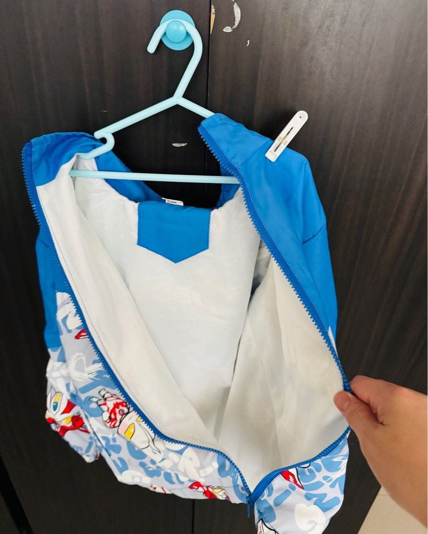 Ultraman Kids' Jacket - Blue (from Taiwan) (Category: Babies & Kids Fashion) located in Singapore. Submitted by jaxnatan (Listing ID 1379193826, Image 1). Description: Adorable Ultraman-themed jacket for kids. Features a blue and white design with Ultraman graphics. Includes a hood and a full zipper. Perfect for keeping your little one warm and stylish. In excellent condition..