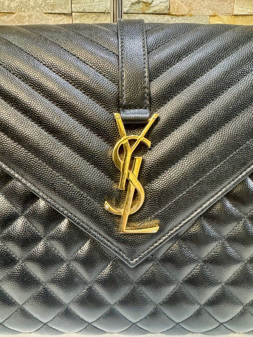 YSL envelope large bag (Category: Luxury Bags & Wallets) located in Taguig. Submitted by angelbellaclaire (Listing ID 1379247465, Image 3). Description: Make a bold statement with the Saint Laurent Large Envelope in black caviar leather, YSL monogram, and versatile chain strap. Approx. size: 12.2” x 8.6” x 2.7”. Perfect for work to weekend.” Inclusion: dustbag, care card and receipt.