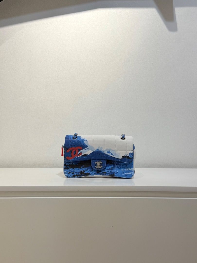 2002 Vintage Chanel Surf Line Flap Bag (Category: Luxury Bags & Wallets) located in Manila. Submitted by designerarchives.ph (Listing ID 1376118013, Image 3). Description: Rare | One of the most sought after Vintage Chanel piece Actual photos are already posted! • circa 2002 • blue/white • canvas • choco bar quilting • surf print • no holo anymore • no inclusions, but will provide replacement packaging 🏷️Vestiaire tag will be included DETAILED P