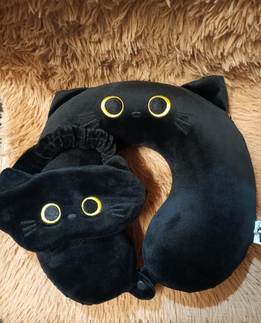 Black Cat-Themed Travel Seat (Category: Travel Essentials & Accessories) located in Subic. Submitted by caekheso_ (Listing ID 1379516165, Image 1). Description: black cat-themed travel set, which includes a U-shaped neck pillow and a matching eye mask. :for kids mallow type mod: 🛒gcash.